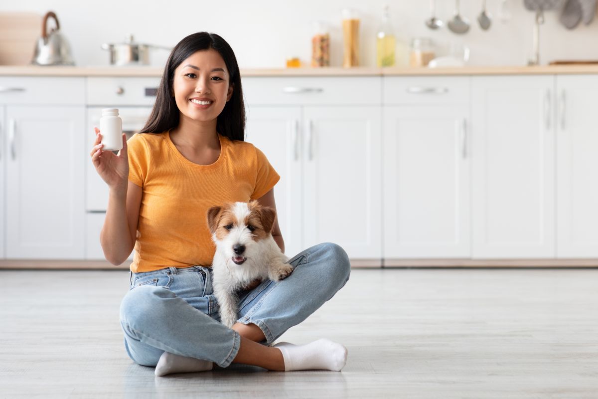 woman with dog supplement and dog beside her